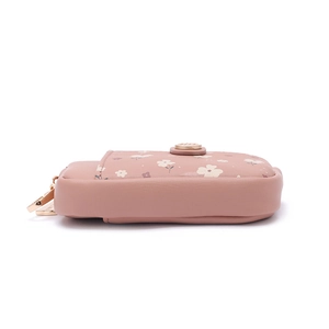 Detail view of pink leather wallet with floral print and golden embossed metal buckle