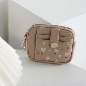 Close-up of floral bifold wallet in beige PU leather with a side metal hook and zipper