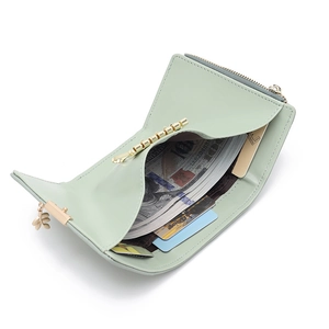 Mini portefeuille femme vert menthe avec zip doré et fentes pour cartes sur fond blanc