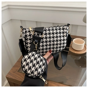 Close-up of houndstooth shoulder bag with gold zipper and detachable coin purse