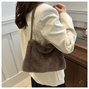 Close-up of fluffy faux mink fur tote bag in brown with sleek shoulder strap details
