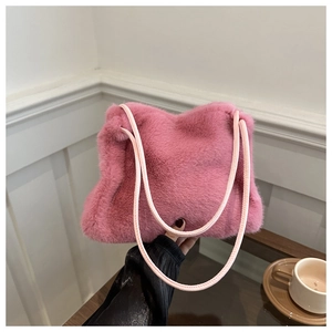 Detailed texture of pink faux fur plush handbag with soft rounded double handles