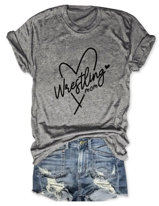 Flat lay of a grey Wrestling Mom t-shirt paired with distressed denim shorts