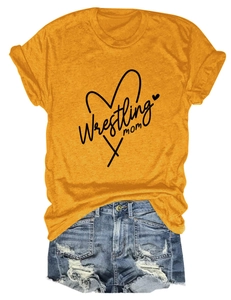 Flat lay of yellow Wrestling Mom t-shirt paired with distressed denim shorts on white background