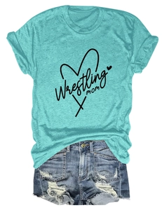 Flat lay of a teal Wrestling Mom T-shirt paired with distressed denim shorts