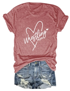 Flat lay of maroon Wrestling Mom t-shirt paired with distressed denim shorts on white background
