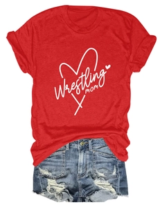 Flat lay of red Wrestling Mom T-shirt paired with distressed denim shorts on white background