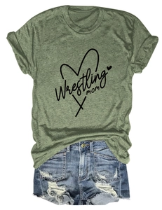 Flat lay of a green Wrestling Mom t-shirt paired with distressed blue denim shorts