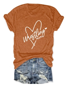 Detail of caramel orange Wrestling Mom t-shirt with heart design and folded sleeve cuffs