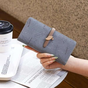 Detail of grey PU leather long wallet with leaf print and metal leaf pendant closure