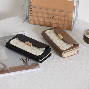 Detailed view of floral PU leather wallets with rabbit buckles and accordion structure