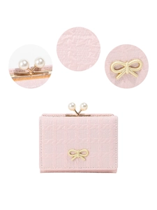 Detail of light pink PU leather wallet with pearl clasp and golden bow decoration