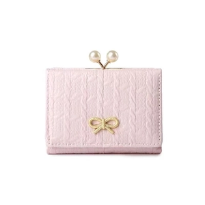 Detail of light pink cable knit wallet with pearl clasp and golden bow decoration