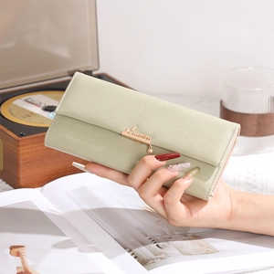 Close-up of mint green trifold long wallet featuring golden leaf metal clasp and card slots