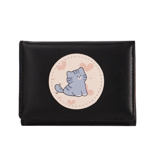 Close-up of black tri-fold wallet featuring a cartoon cat and pink heart on the cover