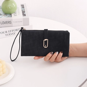 Close-up of black matte PU leather long wallet with gold leaf buckle on a white table