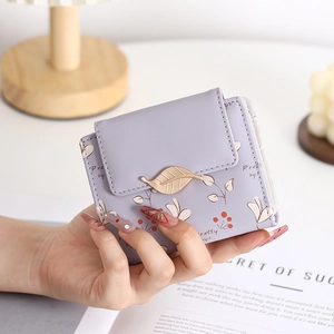 Detailed view of lavender PU leather wallet with floral print and gold leaf clasp