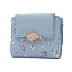 Close-up of light blue PU leather wallet with cherry leaf prints and a gold leaf clasp
