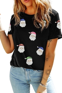 Détail d'un t-shirt noir pour femme avec motifs festifs du Père Noël en paillettes