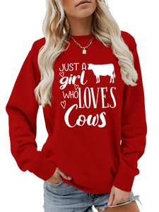 Detail of red crew neck sweatshirt with Just a Girl Who Loves Cows print and ribbed cuffs