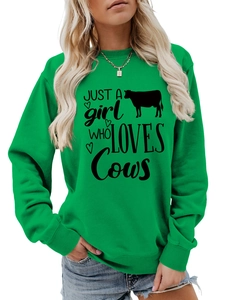Detail of green round neck sweatshirt featuring JUST A girl WHO LOVES Cows text print
