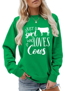 Detail view of the green crewneck sweatshirt featuring white Just a girl who loves Cows print