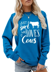Detail of the high-quality cotton fabric and white cow-themed print on blue sweatshirt