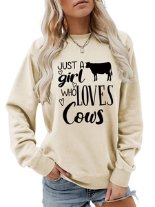 Macro detail of ribbed cuff and high-quality cotton fabric on a cream cow print sweatshirt