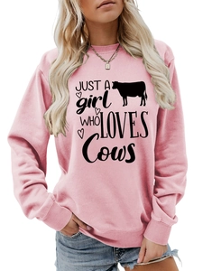 Detail of pink sweatshirt with Just a Girl Who Loves Cows print and soft fabric texture