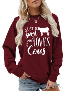 Detail of soft burgundy sweatshirt featuring white Just a Girl Who Loves Cows print