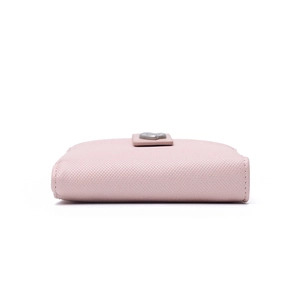 Detailed macro view of pink cross-grain leather wallet with heart metal buckle