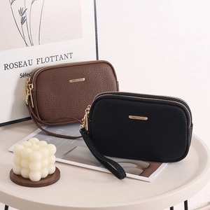 Close-up of double zipper litchi grain faux leather wristlet wallets in brown and black