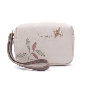 Detailed view of women's mini wallet with bird emblem and leaf pattern by Prettyzys