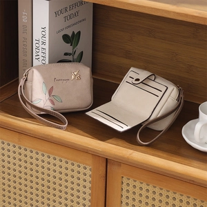 Detailed view of women's floral wallet set showing zipper pouch and internal card slots