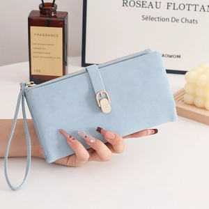 Detail of light blue matte long wallet for women with hand strap and zipper closure