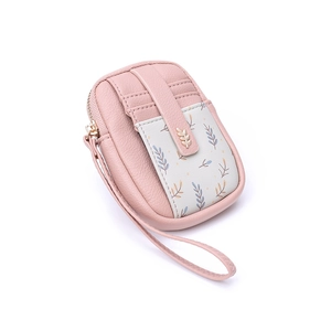 Portefeuille en cuir rose grainé avec breloque feuille dorée et dragonne en vue latérale