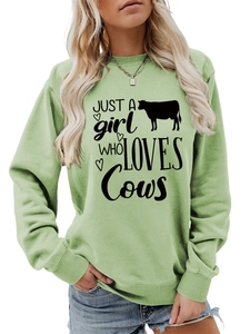 Detail of lime green sweatshirt with Just a girl who loves Cows text and heart graphic