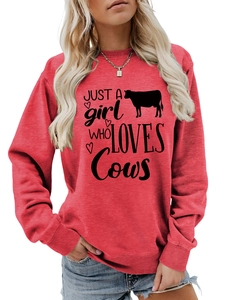 Detail of red crewneck sweatshirt featuring Just A Girl Who Loves Cows graphic print
