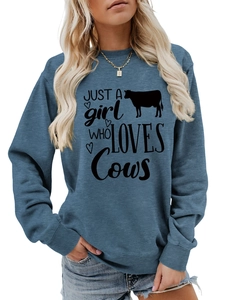 Close-up of Just A Girl Who Loves Cows print on blue long sleeve crewneck sweatshirt