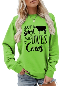 Detail of lime green sweatshirt featuring Just a Girl Who Loves Cows graphic print