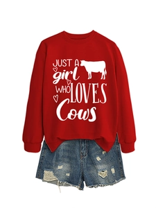Close-up of red crewneck sweatshirt with 'Just a girl who loves cows' graphic print