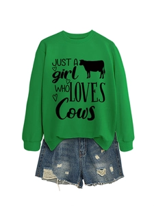 Detail of green cow print sweatshirt with distressed denim shorts for women's outfit