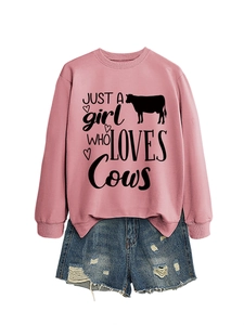 Pink crewneck sweatshirt with Cow love print paired with blue ripped denim shorts