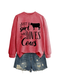 Flat lay of red sweatshirt with Just a Girl Who Loves Cows text and ripped denim shorts
