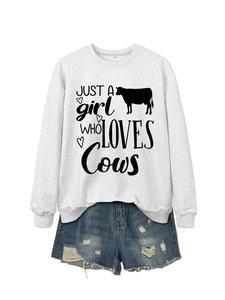 Detail of grey sweatshirt showing 'Just a girl who loves Cows' print and fabric texture