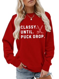 Close-up of red crewneck sweatshirt with Classy Until Puck Drop hockey print