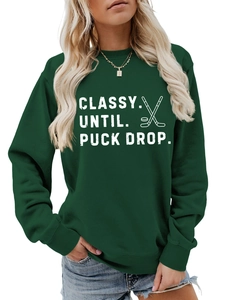 Detail of Classy Until Puck Drop text and hockey graphic on forest green sweatshirt