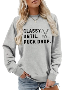 Detail of gray crewneck sweatshirt with Classy Until Puck Drop hockey graphic and ribbed cuffs