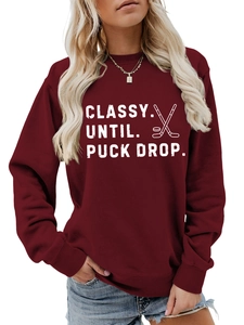 Detail view of burgundy sweatshirt with white Classy Until Puck Drop hockey print