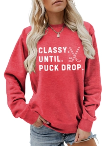 Detail of red crewneck sweatshirt featuring white Classy Until Puck Drop hockey graphics